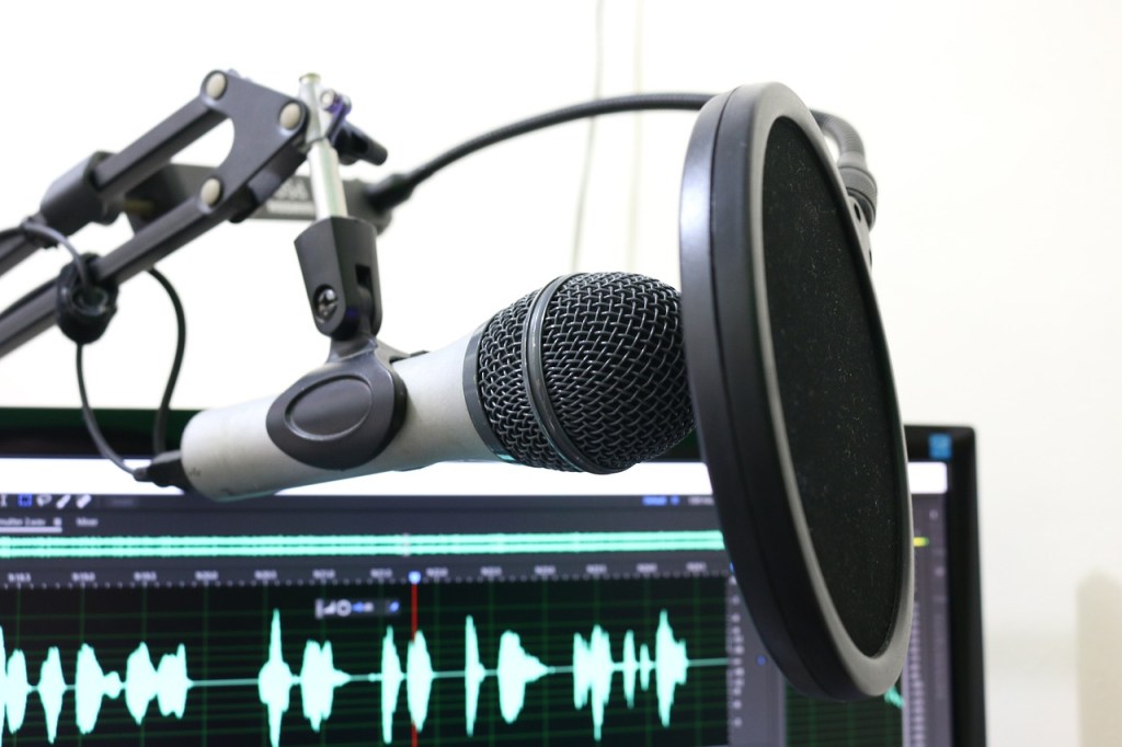 podcast microphone with digital audio waves underneath